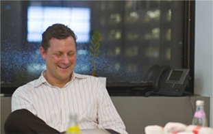 Man sitting in chair laughing