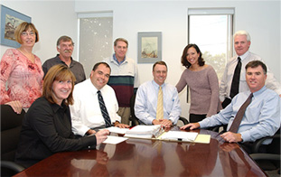 Teams of people sitting around a table